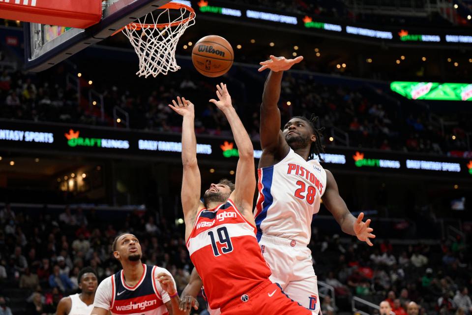 Washington Wizards guard Raul Neto (19) goes to the basket against Detroit Pistons center Isaiah Stewart (28) during the first half of an NBA basketball game Tuesday, March 1, 2022, in Washington. Stewart was called for a foul on the play.