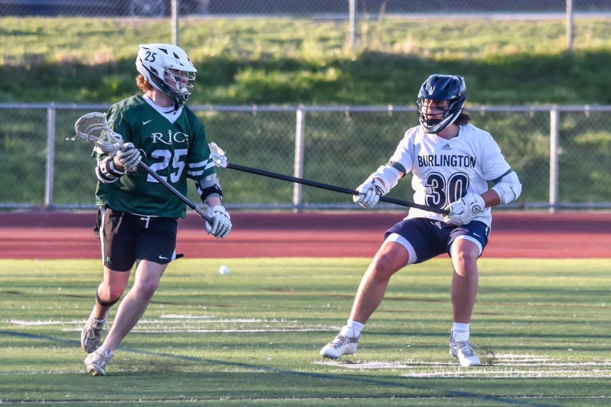 Rice's Andrew Greene works against Burlington's Elliot Laramee during the Green Knights' 10-9 overtime win over the Seahorses on Monday in Burlington.