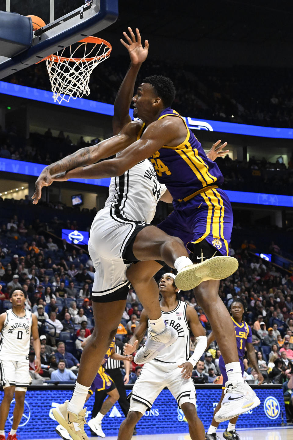 LSU forward Shawn Phillips, top right, misses a shot with Vanderbilt forward Lee Dort, top left, defending during the first half of an NCAA college basketball game in the second round of the Southeastern Conference tournament, Thursday, March 9, 2023, in Nashville, Tenn. (AP Photo/John Amis)