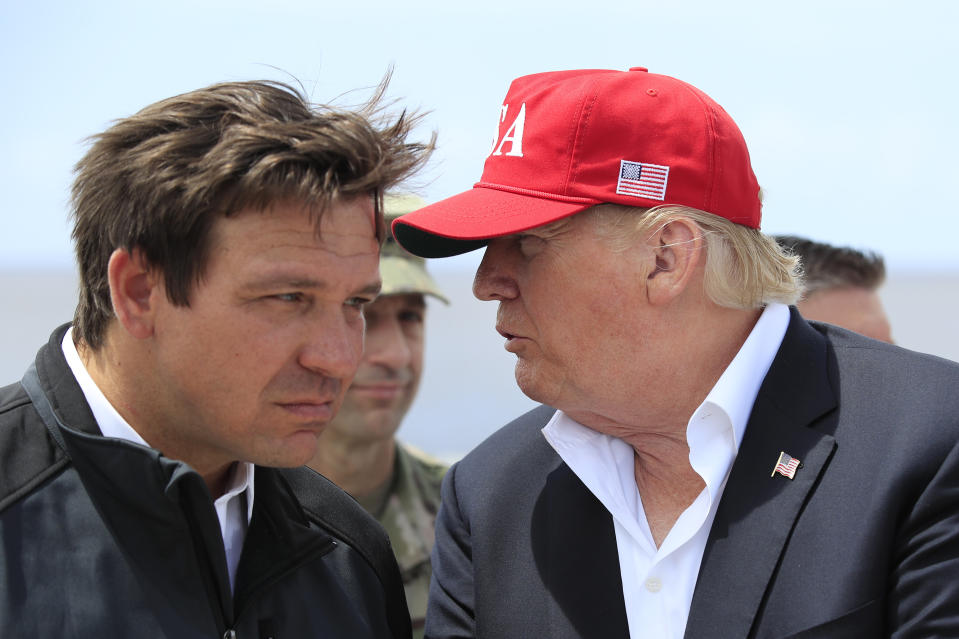 FILE - President Donald Trump talks to Florida Gov. Ron DeSantis, left, during a visit to Lake Okeechobee and Herbert Hoover Dike at Canal Point, Fla., March 29, 2019. (AP Photo/Manuel Balce Ceneta, File)