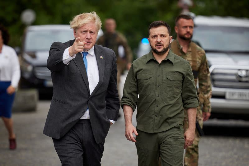 FILE PHOTO: British PM Johnson and Ukraine's President Zelenskiy walk at Mykhailivska Square in Kyiv