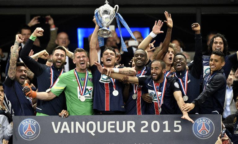 Paris Saint-Germain's Brazilian defender Thiago Silva holds up the trophy as Paris Saint-Germain's players celebrate after winning the French Cup final football match against Auxerre in Saint-Denis, north of Paris, on May 30, 2015