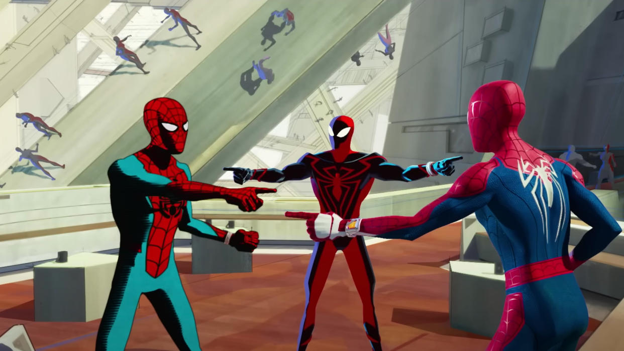  Many Spider-Men variants, including three in the foreground, point at each other in Spider-Man: Across the Spider-Verse. 