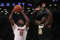 North Carolina State's Jaylon Gibson (11) shoots against Purdue's Trevion Williams (50) during the first half of an NCAA college basketball game Sunday, Dec. 12, 2021, in New York. (AP Photo/Jason DeCrow)