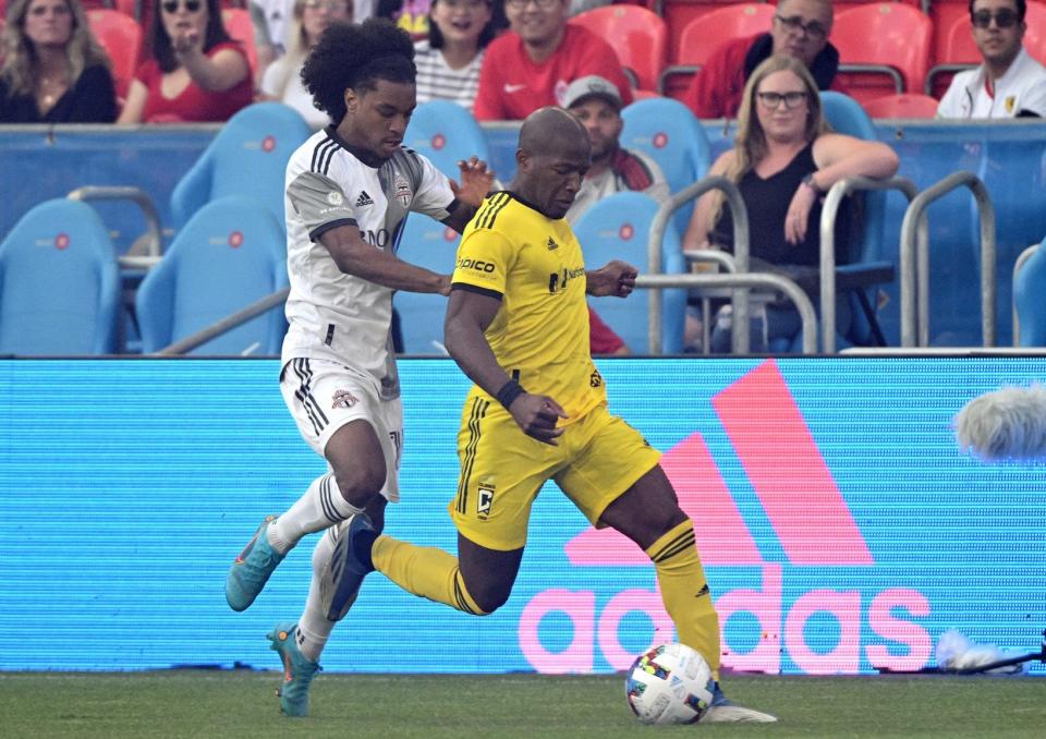 Jun 29, 2022; Toronto, Ontario, CAN; Columbus Crew midfielder Darlington Nagbe (6) battles for the ball with Toronto FC midfielder Jayden Nelson (11) in the first half at BMO Field. Mandatory Credit: Dan Hamilton-USA TODAY Sports