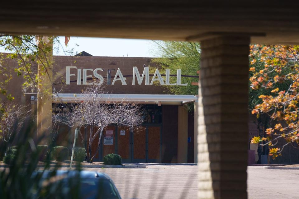 The entrance to Fiesta Mall is boarded up on March 17, 2023, in Mesa.