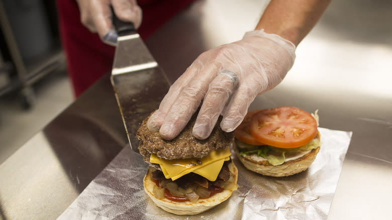 Five Guys employee making burgers