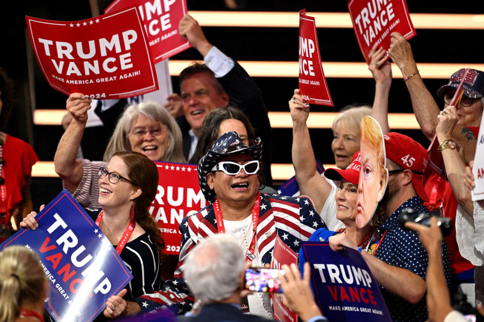 Attendees hold Trump-Vance signs during the second day of the 2024 Republican National Convention at the Fiserv Forum in Milwaukee, Wisconsin, July 16, 2024. (Patrick T. Fallon/AFP - Getty Images)