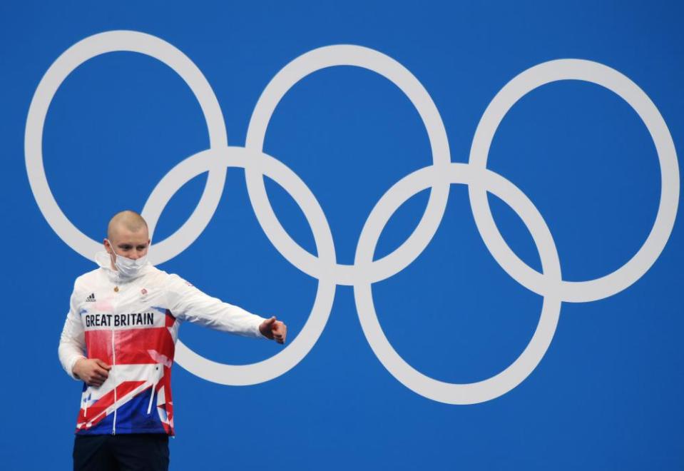 Adam Peaty of Great Britain is seen on the podium with his gold medal.