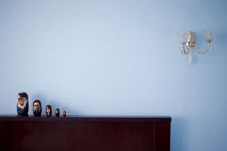 Traditional Russian Matryoshka wooden dolls depicting Russian President Vladimir Putin are seen in in this photo illustration taken in a hotel room in Kazan, Russia, July 30, 2015. REUTERS/Stefan Wermuth