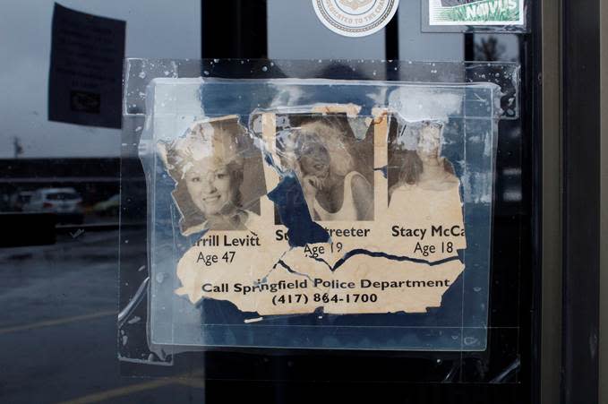 A tattered missing persons poster depicts Sherrill Levitt, Suzanne "Suzie" Streeter and Stacy McCall in the window of Coyote's Adobe Café in Springfield.