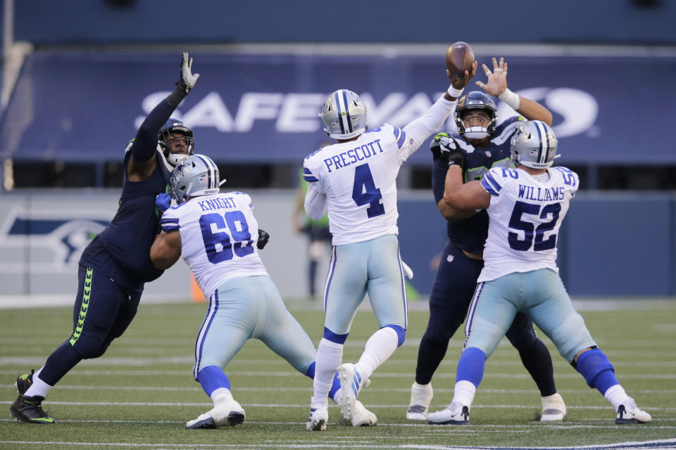 Dallas Cowboys quarterback Dak Prescott (4) passes under pressure to wide receiver Michael Gallup for a touchdown during the second half of an NFL football game, Sunday, Sept. 27, 2020, in Seattle. (AP Photo/John Froschauer)