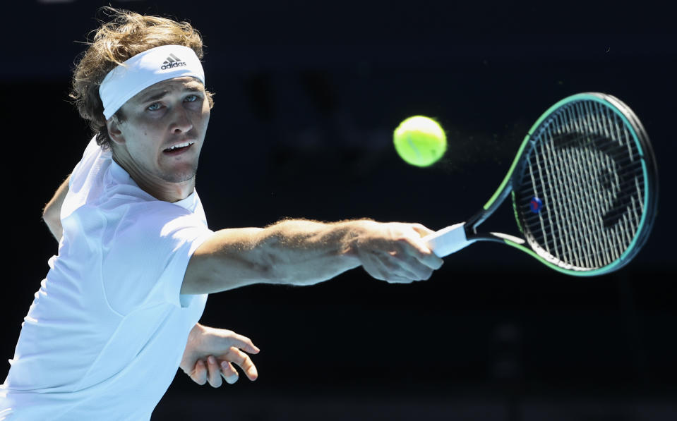 Germany's Alexander Zverev makes a backhand return to Canada's Denis Shapovalov during their ATP Cup match in Melbourne, Australia, Wednesday, Feb. 3, 2021. (AP Photo/Hamish Blair)