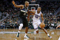 Sacramento Kings guard Harrison Barnes (40) dribbles the ball as Milwaukee Bucks forward Khris Middleton (22) defends during the first half of an NBA basketball game Saturday, Jan. 22, 2022, in Milwaukee. (AP Photo/Jon Durr)