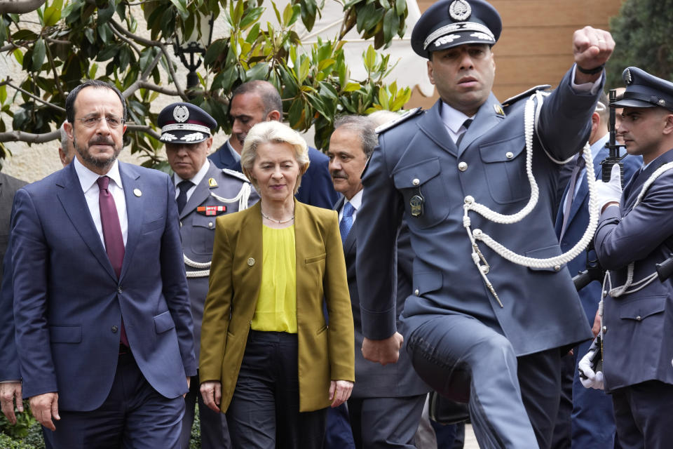 Cyprus' President Nikos Christodoulides, left, and President of the European Commission Ursula von der Leyen, center, review an honor guard upon their arrival to meet with the Lebanese Speaker Nabih Berri, in Beirut, Thursday, May 2, 2024. (AP Photo/Hussein Malla)