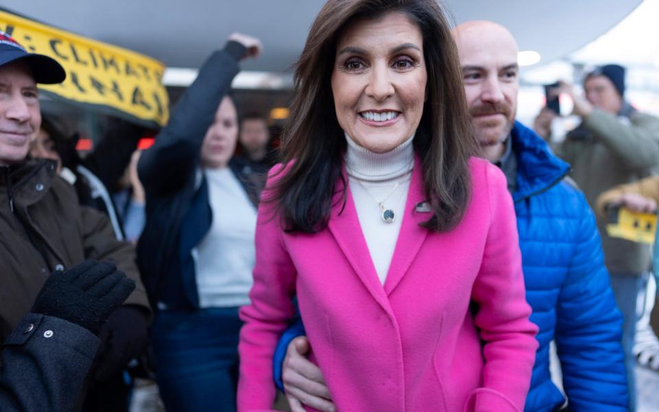 Republican presidential candidate former UN Ambassador Nikki Haley moves with security through the crowd to a waiting vehicle after a campaign event at Drake Diner, in Des Moines,