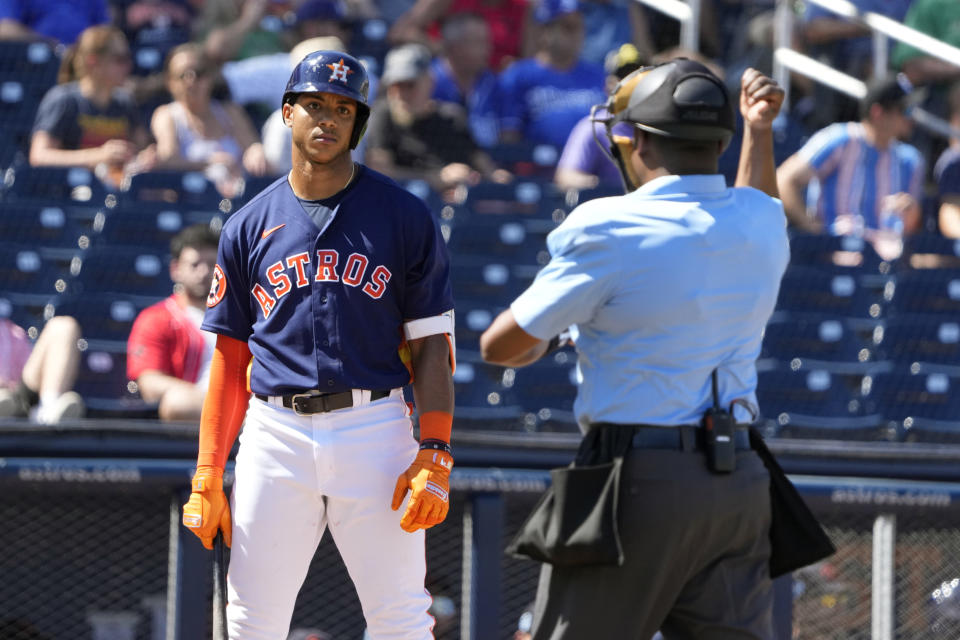 Houston Astros' Jeremy Pena, left, watches is as he is called out on an automatic strike by home plate umpire Ramon De Jesus after time on the clock ran down on Pena during the third inning of a spring training baseball game against the Boston Red Sox Wednesday, March 1, 2023, in West Palm Beach, Fla. (AP Photo/Jeff Roberson)