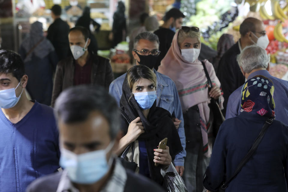 People wear protective face masks to help prevent the spread of the coronavirus in the Tajrish traditional bazaar in northern Tehran, Iran, Thursday, Oct. 15, 2020. Eight months after the pandemic first stormed Iran, pummeling its already weakened economy and sickening officials at the highest levels of its government, authorities appear just as helpless to prevent its spread. (AP Photo/Ebrahim Noroozi)