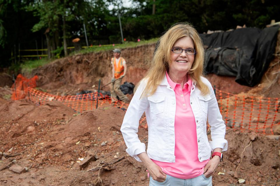 Conda Painter stands near the site of an old cemetery in West Asheville June 22, 2023.