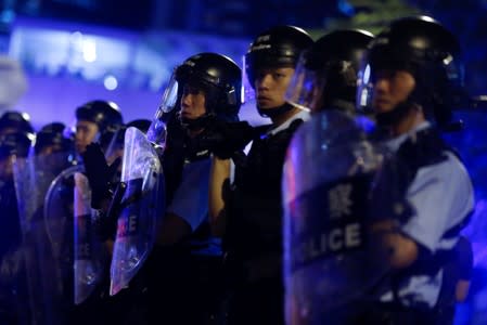 Riot police officers stand guard outside the Legislative Council during a protest to demand authorities scrap a proposed extradition bill with China in Hong Kong