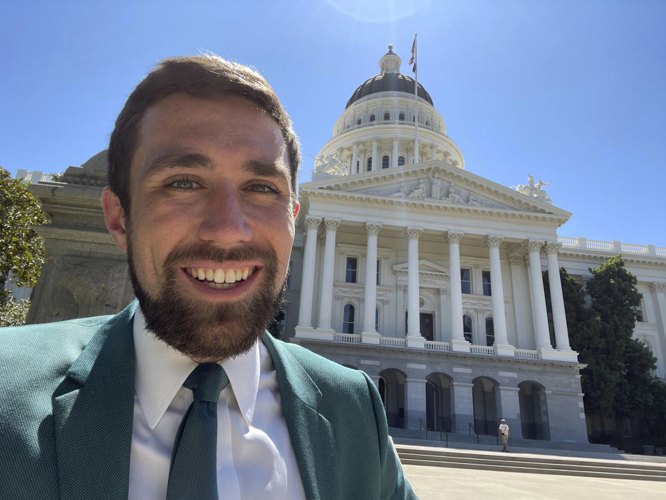 In a photo provided by Kevin Paffrath, Kevin Paffrath smiles for a selfie in front of the California State Capitol in Sacramento on Friday, July 16, 2021. The 29-year-old YouTuber is one of the Democrats running in the recall against California Gov. Gavin Newsom. Paffrath's videos typically touch on real estate and investment advice, and he's never held public office. (Kevin Paffrath via AP)