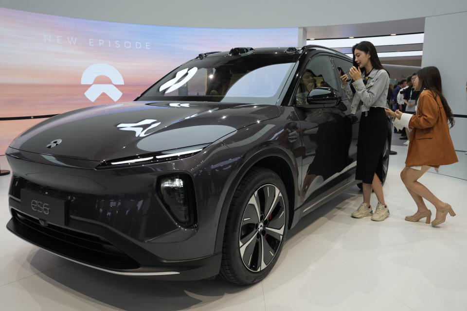 Attendees look at the es6, the latest electric vehicle from Chinese automaker NIO during the Auto Shanghai 2023 show in Shanghai, Tuesday, April 18, 2023. Global and Chinese automakers plan to unveil more than a dozen new electric SUVs, sedans and muscle cars this week at the Shanghai auto show, their first full-scale sales event in four years in a market that has become a workshop for developing electrics, self-driving cars and other technology. (AP Photo/Ng Han Guan)