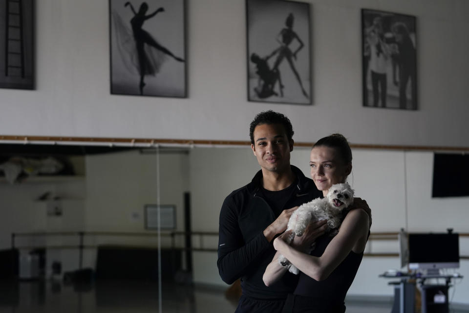 Adrian Blake Mitchell, left, and Andrea Laššáková pose for a photo with their dog, Beau, on Monday, April 18, 2022, in Santa Monica, Calif. The dancers left their positions at the Mikhailovsky Ballet Theatre in St. Petersburg and fled Russia ahead of the invasion of Ukraine. (AP Photo/Ashley Landis)