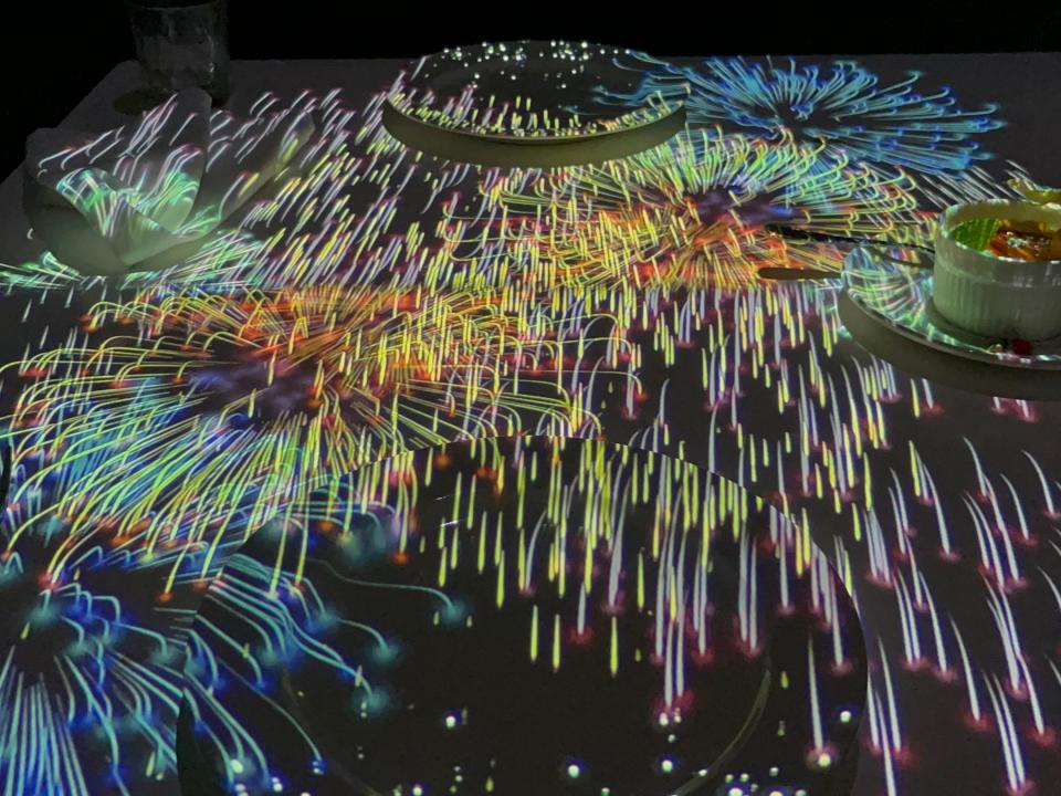 Colorful firework show projected onto table at Le Petit Chef