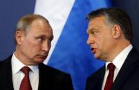 Russian President Vladimir Putin (L) listens to Hungarian Prime Minister Viktor Orban before a joint news conference in Budapest in this February 17, 2015 file photo. REUTERS/Laszlo Balogh/Files