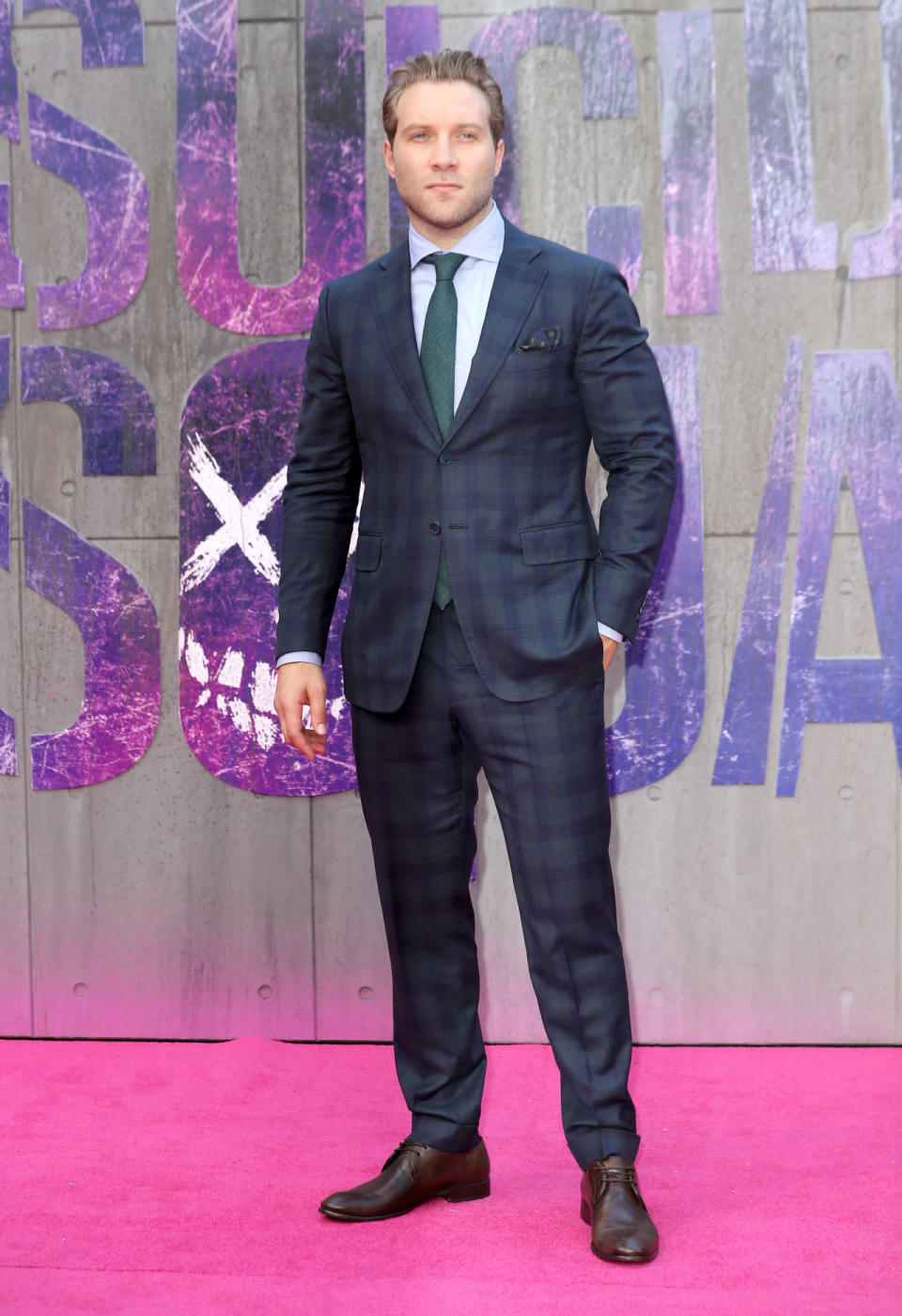 Jai Courtney in a green and navy blue tartan print suit 