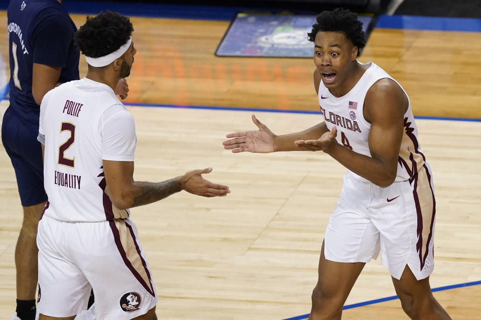 Florida State guard Scottie Barnes (4) reacts to a foul called on him as teammate guard Anthony Polite (2) looks on during the second half of an NCAA college basketball Championship game against Georgia Tech at the Atlantic Coast Conference tournament in Greensboro, N.C., Saturday, March 13, 2021. (AP Photo/Gerry Broome)