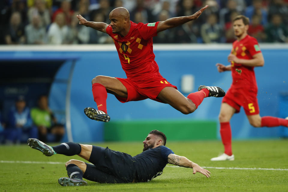 <p>France’s forward Olivier Giroud (bootm) falls past Belgium’s defender Vincent Kompany during the Russia 2018 World Cup semi-final football match between France and Belgium at the Saint Petersburg Stadium in Saint Petersburg on July 10, 2018. (Photo by Odd ANDERSEN / AFP) </p>