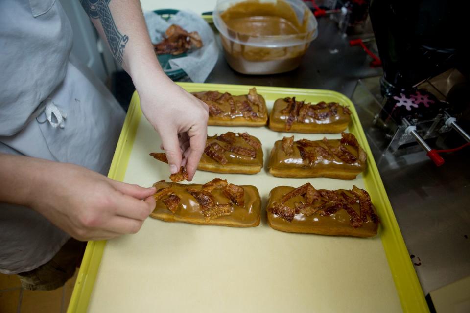 A Maple Bacon Bar gets extra bacon at the Jupiter Donut Factory location in Royal Palm Beach.  