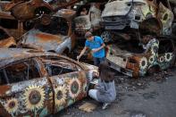 Artists painte cars destroyed during Russia's attack on Ukraine in Irpin