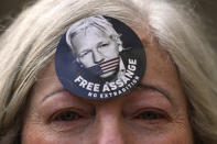 A woman wears a Free Assange badge as supporters of Julian Assange stage a demonstration outside the High Court in London, Wednesday, Oct. 27, 2021. The U.S. government is scheduled to ask Britain's High Court to overturn a judge's decision that WikiLeaks founder Julian Assange should not be sent to the United States to face espionage charges. A lower court judge refused extradition in January on health grounds, saying Assange was likely to kill himself if held under harsh U.S. prison conditions. (AP Photo/Kirsty Wigglesworth)