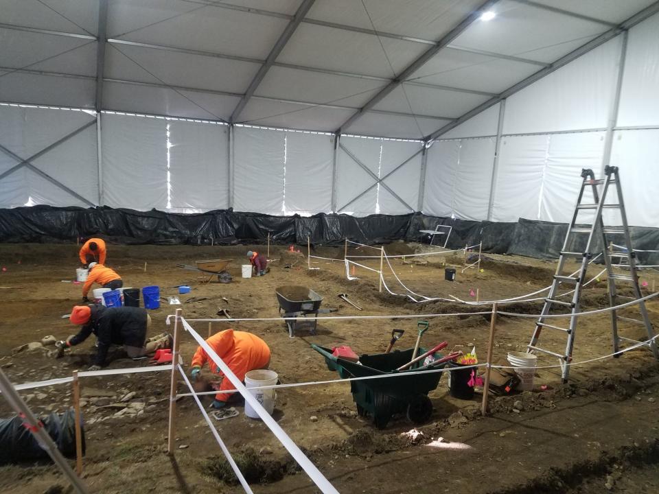 Members of the Independent Archaeological Consulting crew excavate the most recently opened area inside the tent at the Preble Site at 142 York Street in York, Maine, on Friday, Jan. 19, 2022.