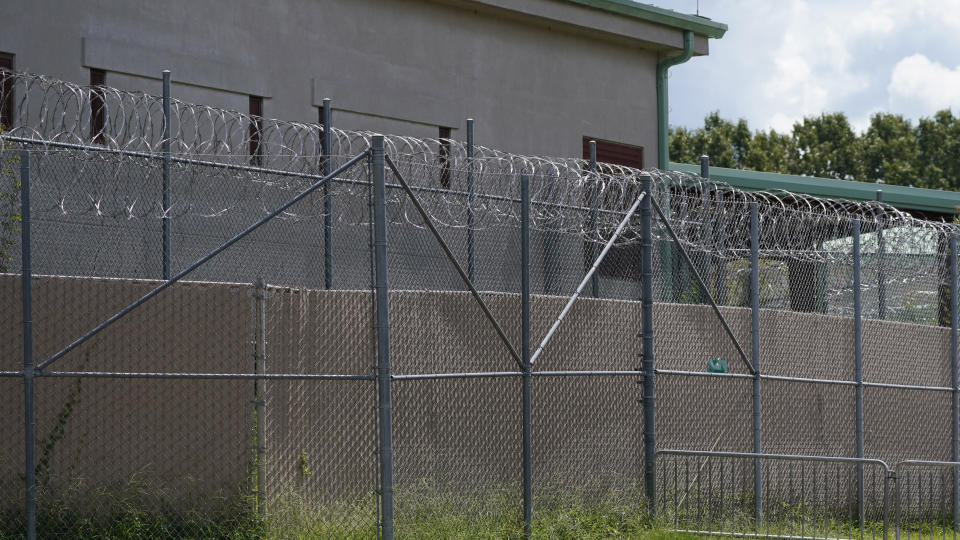 FILE - Rolls of razor wire line the top of the security fencing at the Raymond Detention Center in Raymond, Miss., Aug. 1, 2022. A man who escaped from the Mississippi jail on April 22, 2023, has been founded dead at a truck stop in New Orleans, authorities announced Tuesday, May 2. (AP Photo/Rogelio V. Solis, File)