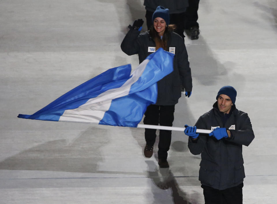 Argentina's flag-bearer Cristian Simari Birkner leads his country's contingent during the opening ceremony of the 2014 Sochi Winter Olympics, February 7, 2014. REUTERS/Lucy Nicholson (RUSSIA - Tags: OLYMPICS SPORT)