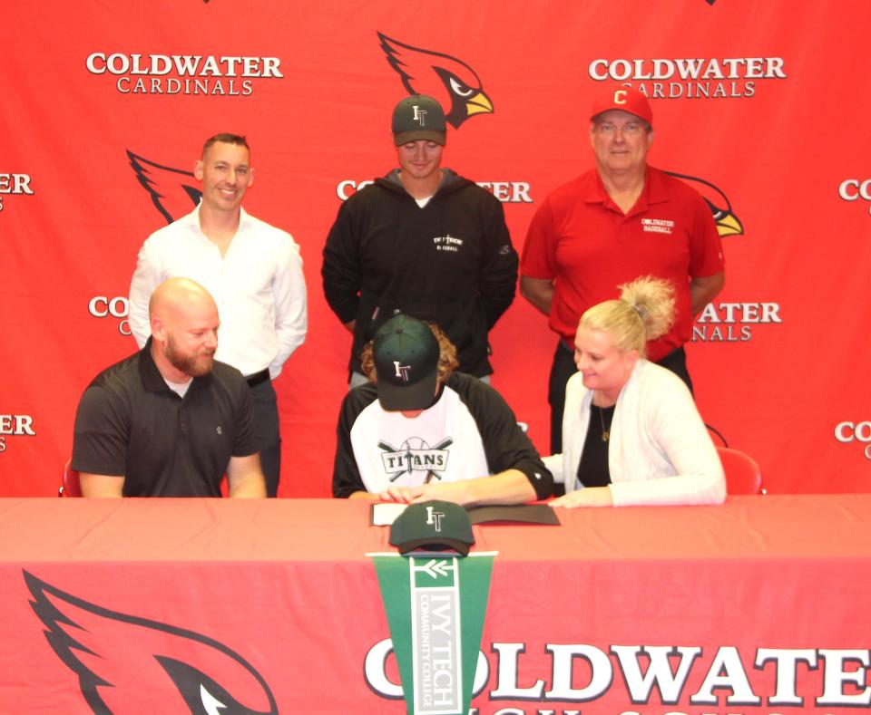 Coldwater’s Nate Tappenden signs his letter of intent to play baseball at Ivy Tech CC. Nate is joined by his pitching coach (top left to right) Andrew Paulun, Ivy Tech coach Connor Wilkins, and Coldwater head coach Randy Spangler. Also joining Nate are his parents Kevin Tappenden and Andrea Chamberlain.