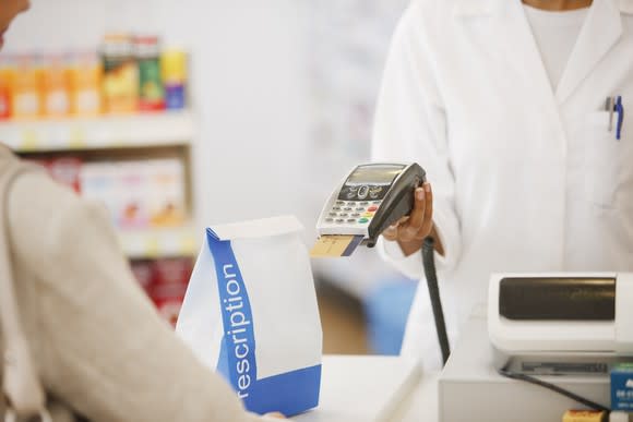 Customer checking out at pharmacy counter