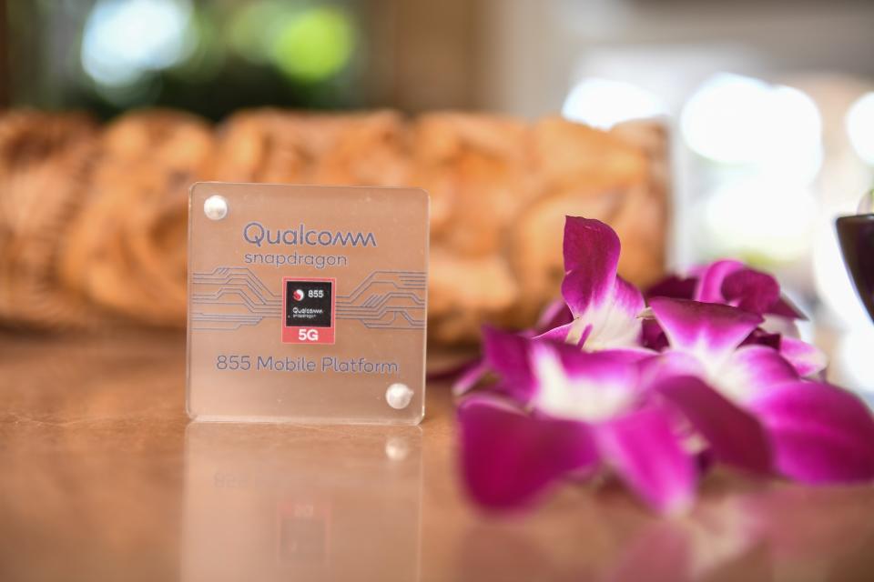 A Snapdragon 855 chip next to flowers.