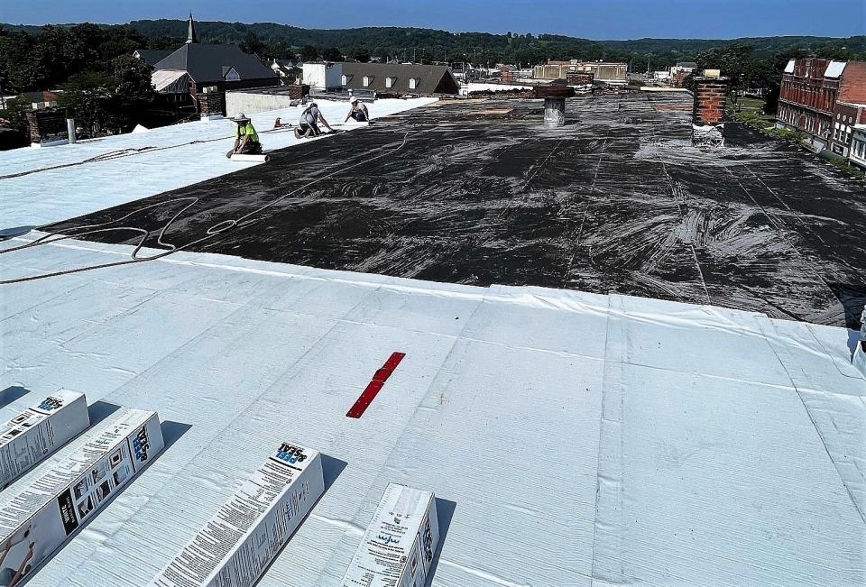 Crews work on the roof of the Selby building. While there is more remodeling to be done, the gaping whole in the roof has been closed and weatherized to prevent any further interior damage.