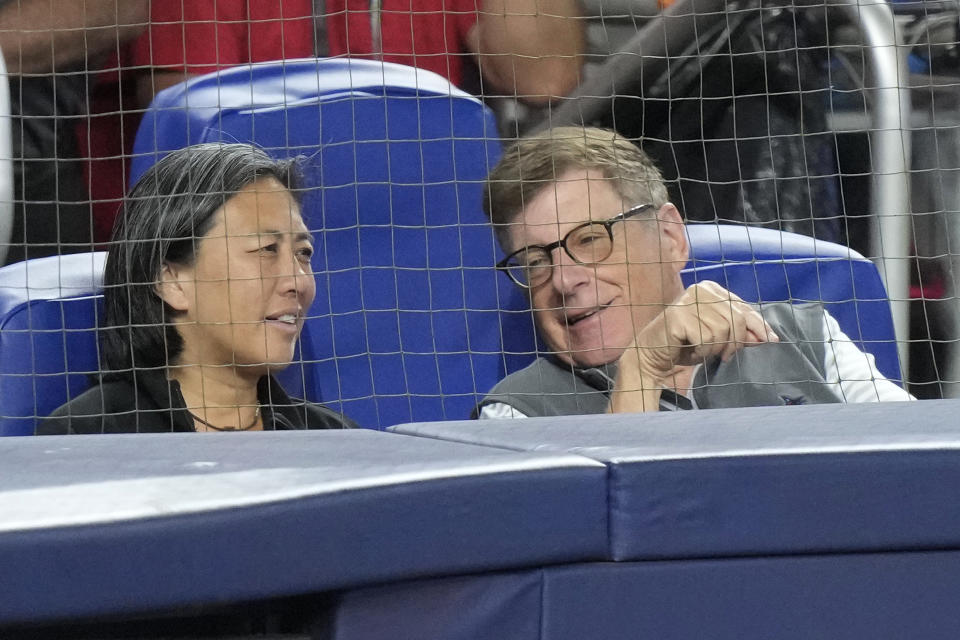 FILE - Bruce Sherman, right, Miami Marlins chairman and principal owner chats with Kim Ng, Marlins general manager, as they watch during the fourth inning of a baseball game against the Cincinnati Reds, Saturday, May 13, 2023, in Miami. Kim Ng is leaving the Miami Marlins after three seasons as their general manager, Marlins chairman and principal owner Bruce Sherman said Monday, Oct. 16, 2023.(AP Photo/Wilfredo Lee, File)