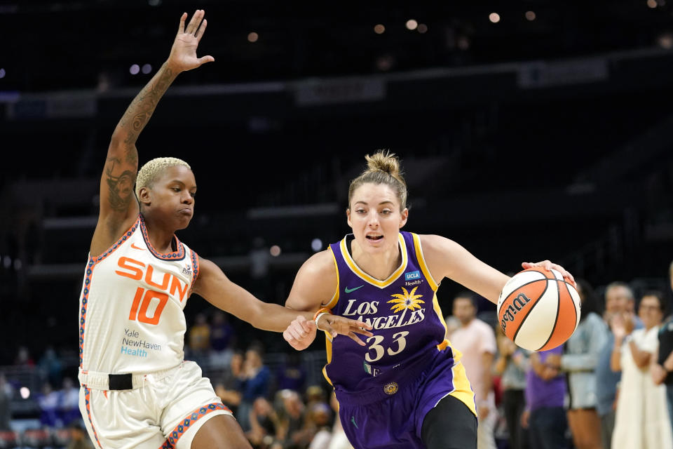 FILE - Los Angeles Sparks forward Katie Lou Samuelson, right, drives past Connecticut Sun guard Courtney Williams during the first half of a WNBA basketball game, Aug. 11, 2022, in Los Angeles. Samuelson, the former UConn star and current WNBA player, has been hired as Vanderbilt's director of player development for women's basketball. Samuelson will assist with recruiting and strategy for Vanderbilt during her offseason, the school announced Sunday, Jan. 22, 2023. (AP Photo/Mark J. Terrill, File)