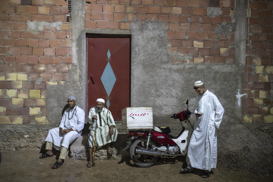 Members of the Sufi Karkariya order observe a religious celebration of the birthday of the prophet Muhammed, in Aroui, near Nador, eastern Morocco, Monday, Oct. 18, 2021. It was the first such gathering since the pandemic. The order, the Karkariya, follows a mystical form of Islam recognizable by its unique dress code: A modest yet colorful patchwork robe. (AP Photo/Mosa'ab Elshamy)