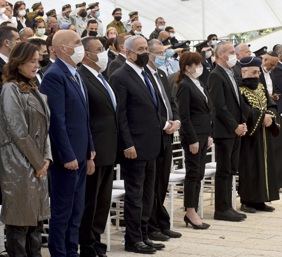 Israeli Prime Minister Benjamin Netanyahu, center, attends at a memorial ceremony for fallen soldiers at the Yad LeBanim House on the eve of Memorial Day, in Jerusalem, Tuesday, April 13, 2021. (Debbie Hill/Pool Photo via AP)