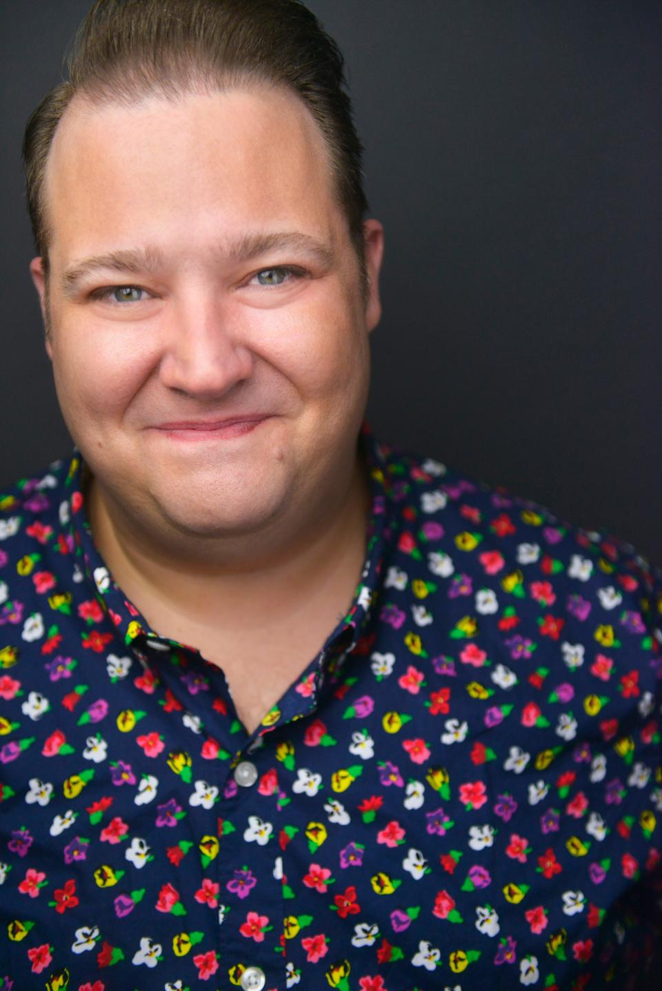 Josh Lamon in a dark blue patterned shirt.