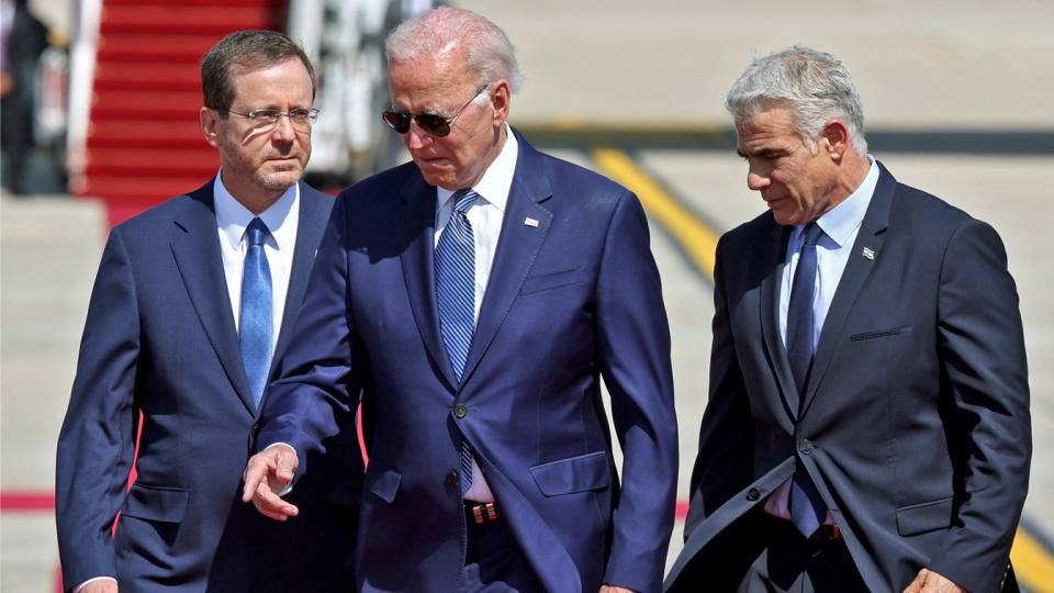 President Biden, Isaac Herzog and Yair Lapid walk together.