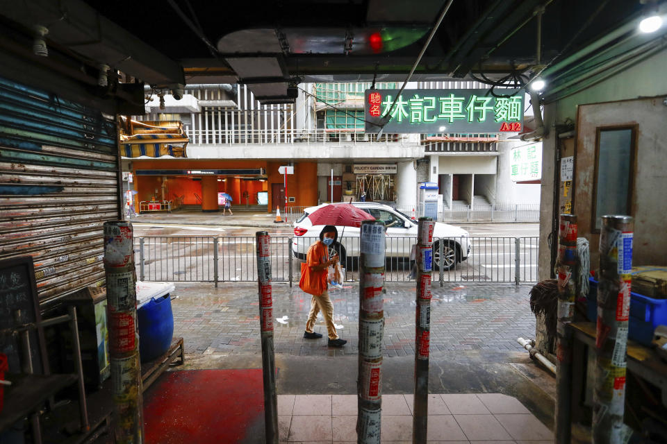 A woman holding an umbrella walks past a shuttered store at a food centre as super typhoon Saola approaches Hong Kong on Friday, Sept. 1, 2023. Most of Hong Kong and parts of southern China ground to a near standstill as Super Typhoon Saola edged closer Friday. (AP Photo/Daniel Ceng)