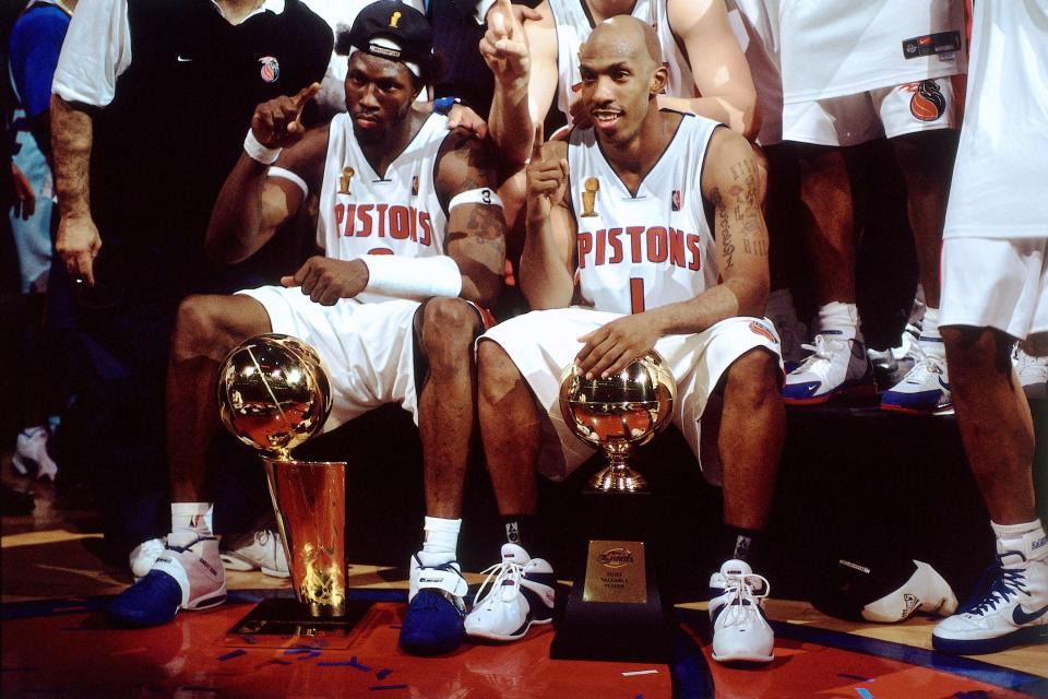 Ben Wallace has the Larry O'Brien Trophy and Chauncey Billups has his NBA Finals MVP Award. (Getty Images)